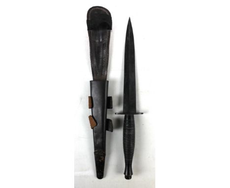 A WWII period military issued Fairbairn-Sykes style commando dagger, with ribbed grip and guard bearing military broad arrows