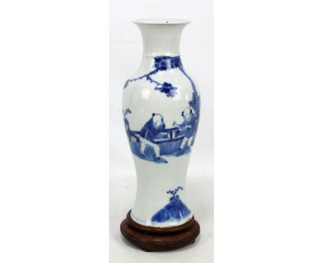 A 19th century Chinese porcelain baluster vase with flared neck and everted rim, painted in underglaze blue with a female and