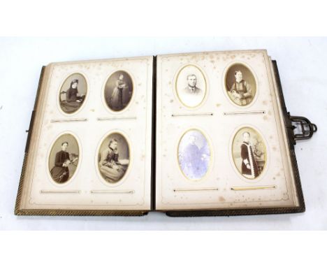 A Victorian Press gilt heightened leather bound musical photo album containing portrait photographs.
