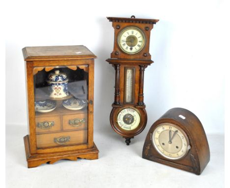 An early 20th century oak smoker's cabinet with ceramic jar and pair of dishes, the two drawers containing a small group of s