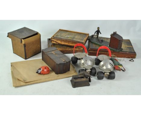 A small collection of early 20th century toys and games including a football bank, a pair of Meccano 'Super Skates', a tinpla