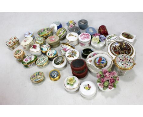 A collection of porcelain and enamel trinket boxes including Halcyon Days and Coalport examples.