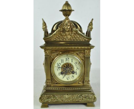 A decorative brass eight day mantel clock with shaped case and circular dial set with Arabic numerals, height 39cm.