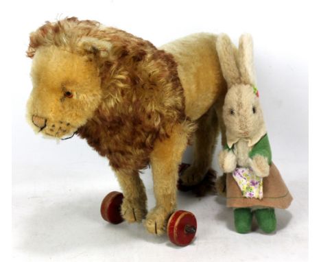 A mid-20th century Steiff Button in Ear lion on wheels, length 35cm, also a straw filled dog with leather collar and leash an