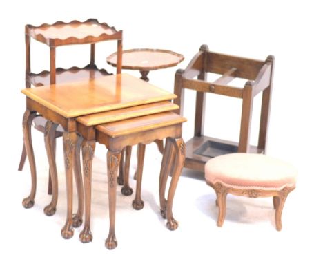 A reproduction walnut wine table, height 53cm, a footstool, an oak stick stand, a nest of three tables and an occasional tabl