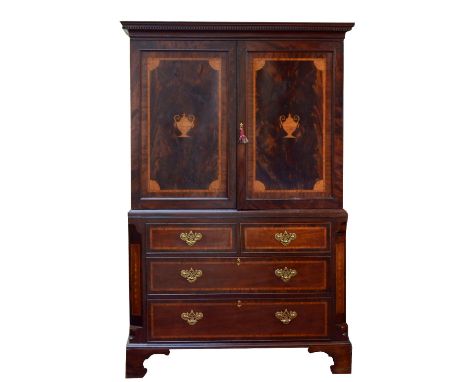 A George III mahogany, rosewood and satinwood crossbanded linen press, with dentil moulded cornice and inlaid twin panelled d