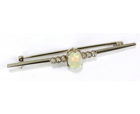 An 18ct white gold and platinum bar brooch centred with opal oval cabochon flanked by six round cut melee diamonds, length 6.