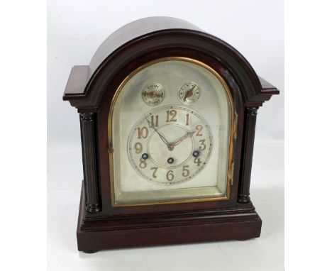 A dome top mantel clock, the silvered chapter ring set with Arabic numerals below chime/silent and slow/fast dials, the movem