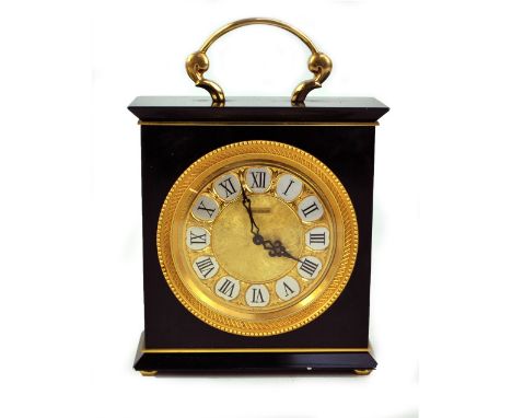 JAEGER LECOULTRE; a black mantel clock, the gilt circular dial set with Roman numerals and with fixed handle to top on four g