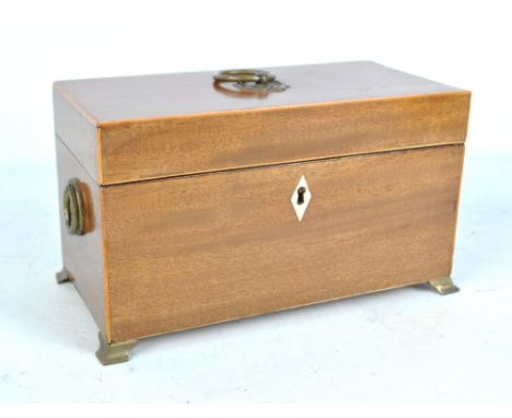 A Regency and later mahogany and line inlaid tea caddy with loop handles, ivory escutcheon and ogee bracket feet, width 25cm.