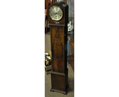 An early 20th century oak eight day grandmother clock, the dial set with Arabic numerals on bracket feet, height 127cm.