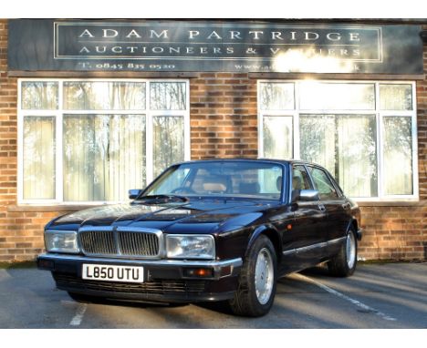 A 1994 Jaguar XJ40 Sovereign in metallic burgundy with gold pin stripe and 16" alloy wheels, the interior fitted with cream l