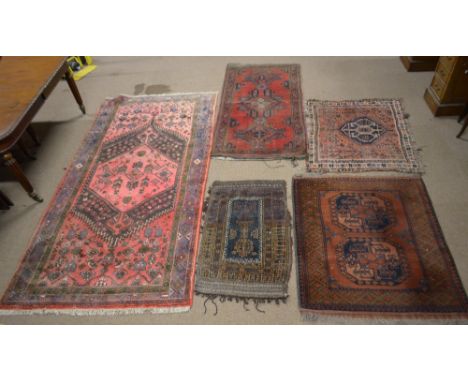 A Hamadan type rug with pink/red ground, animals and various device set main panel, centred with a large lozenge within a sty