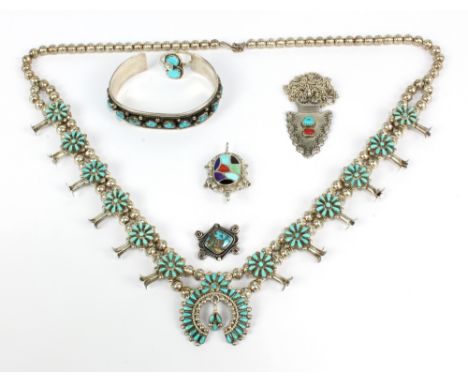 A group of Native American jewellery including a Navajo turquoise set bracelet, a turquoise set brooch, a necklace, stylised 