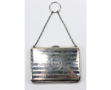 CHARLES S GREEN &amp; CO LTD; a hallmarked silver rectangular purse with linear engine turned decoration, centred with a circ