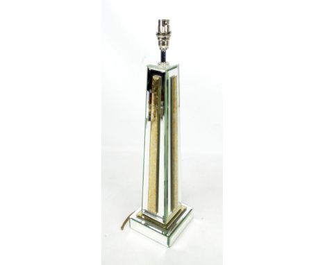 A modern mirrored glass lamp base.