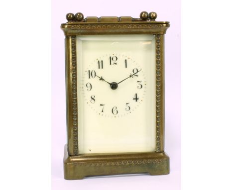 A French brass carriage clock, the rectangular face set with circular dial with Arabic numerals, stamped 'R &amp; Co, made in