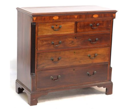 An early 19th century mahogany chest of two short and three long drawers with inlaid frieze and fluted pilasters on bracket f
