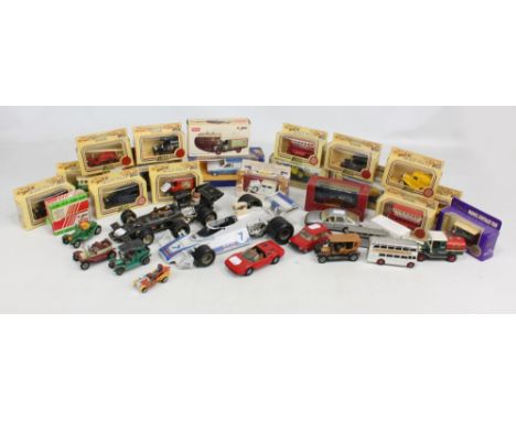 A group of model cars with boxed including Corgi, Lledo, etc, and further loose including two Formula 1 cars.