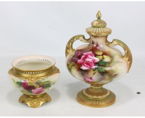 A Royal Worcester porcelain footed vase and cover of stepped globular form with leaf mould twin handles, painted with floral 