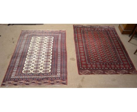 A Tekke design rug with central panel set with four rows of elephant foot medallions within a floral decorated stepped border