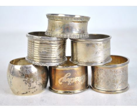 Six variously hallmarked silver circular napkin rings to include an engine turned decorated example with circular cartouche i