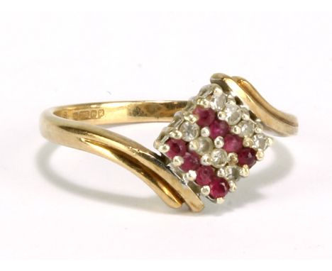 A 9ct yellow gold ring, the platform set with alternating rows of diamonds and ruby coloured stones, size M, approx 2.2g.