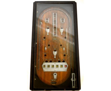 A vintage pinball machine with ebonised frame and raised on square sectioned legs, length approx 98cm. CONDITION REPORT: Appe