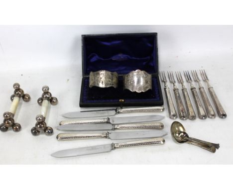 JOSIAH WILLIAMS &amp; CO; a cased pair of Victorian hallmarked silver napkin rings, London 1896, a George IV caddy spoon, Uni