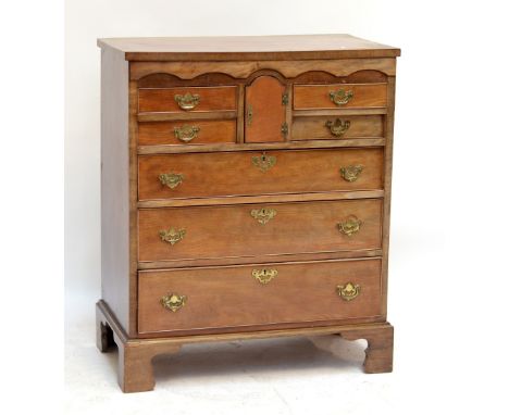 A mahogany and walnut crossbanded chest of drawers of small proportions, the rectangular top above central arched cupboard do