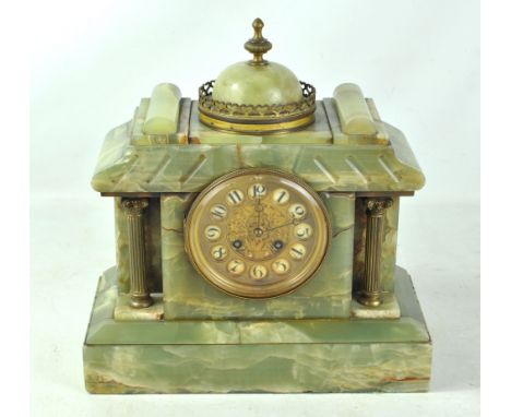 A late 19th century French onyx mantel clock of architectural form, the circular dial set with Arabic numerals, the movement 