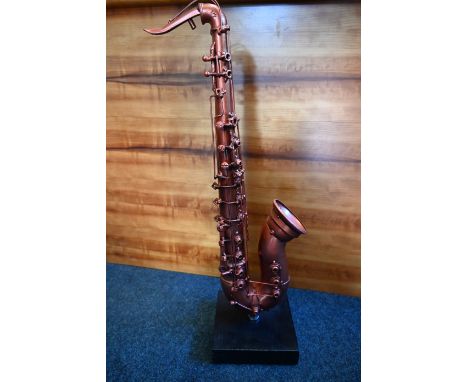 Saxophone sculpture made from old screws, washers, pipes etc on a wood base, approx 68cm tall