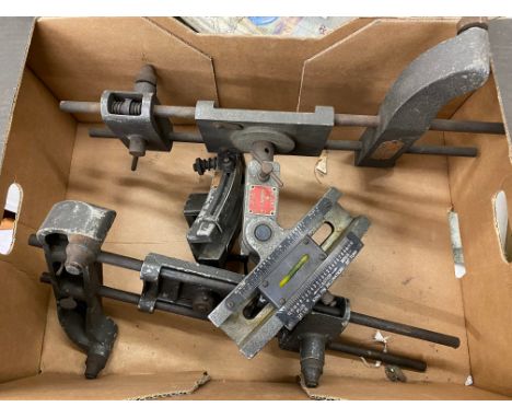 A box containing a pair of camber/alignment tools. 
