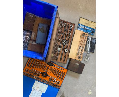A selection of boxed precision tools, including taps and dies.