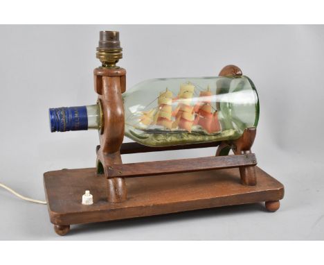 An Early/Mid 20th century Table Lamp in the Form of a Ship in a Bottle, 29cms Wide 