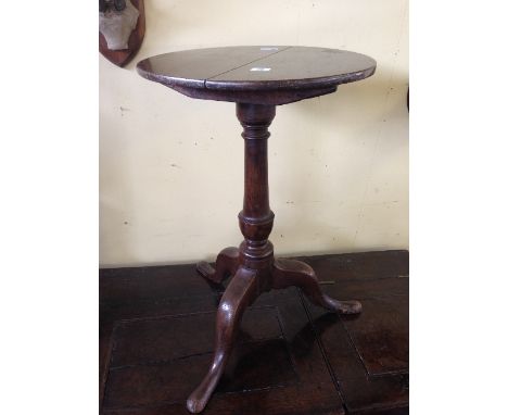 A small 19th century oak occasional table, resting on tripod support.