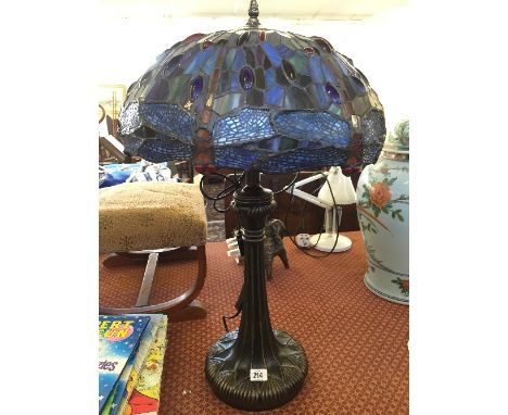 A composition table lamp base with Tiffany style leaded Dragonfly shade.