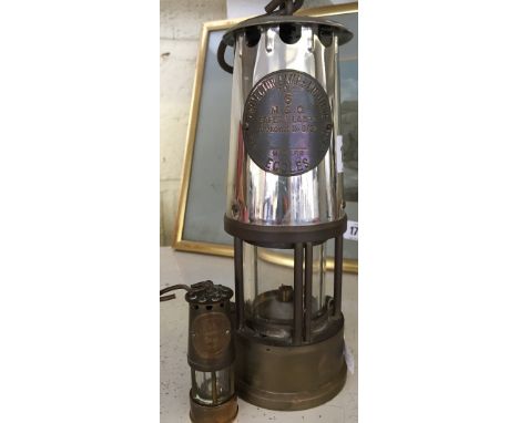 An early 20th century brass and metal miner's lamp by the Protector Lamp & Lighting Co. Ltd, M & Q Safety Lamps Type 6 togeth