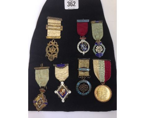 A collection of seven various 19th century and later Masonic silver and enamel badges and ribbons including a 9 carat gold mo