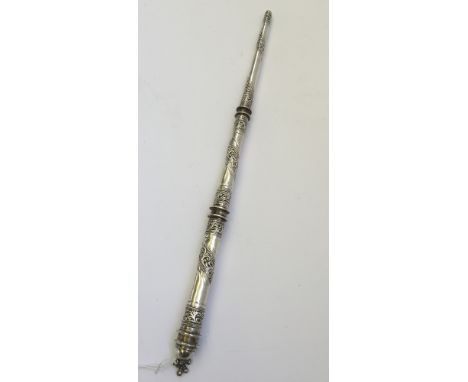 An Eastern silver baton, possibly used as a camel whip, with spiral repousse foliate decoration.