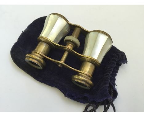 A pair of early 20th century mother of pearl mounted opera glasses in felt bag.