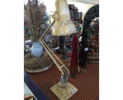 An early 20th century Herbert Terry angle poise table lamp with gold and cream paint decoration.