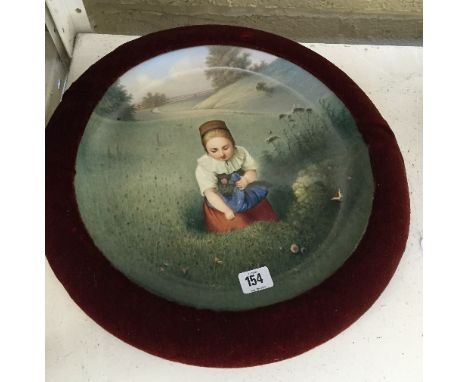 A large velvet framed 19th century circular hand painted Dresden china plaque, signed to reverse and decorated with a Young G