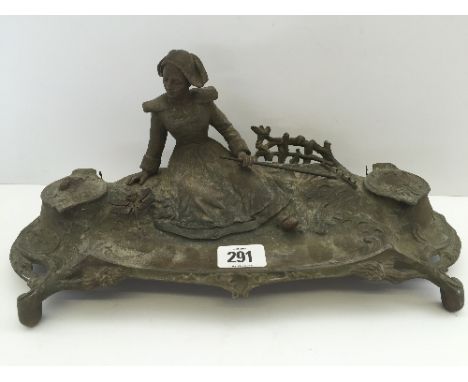 A turn of the century Art Nouveau French Spelter automaton desk pen tray modelled as a Dutch Girl holding a rake, the twin in