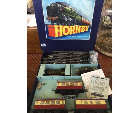 A mid 20th century Hornby tinplate O gauge model railway set with engine, tender and three carriages together with track in o