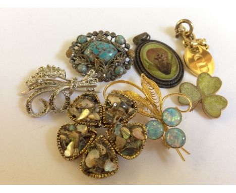 A small quantity of various costume jewellery brooches including opal set gold coloured brooch.