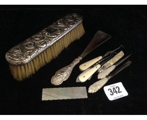 A silver backed hairbrush together with a silver handled shoehorn, mother of pearl button hooks and similar items and a Chine