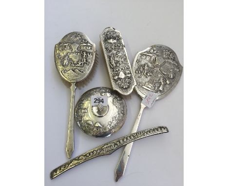 An early 20th century good quality Indian silver dressing table set comprising powder pot, two brushes, hand mirror and comb 