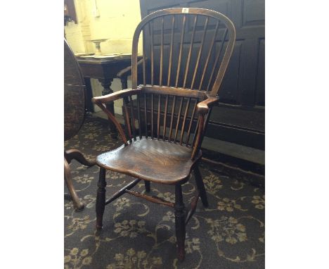 A 19th century stick back ladies' Windsor chair, resting on cross stretcher turned supports.