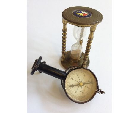 A souvenir SS Arcadia brass egg timer together with a compass with folding binocular eye glasses.